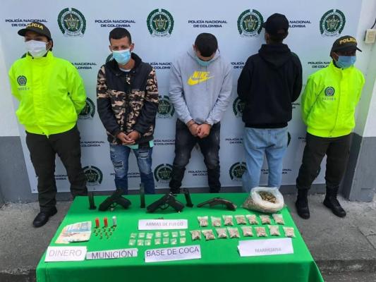 3 personas capturadas-policías custodiando