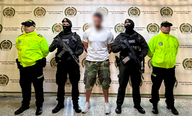 Alias "El Franc&eacute;s" es custodiado por cuatro polic&iacute;as, en el backing.