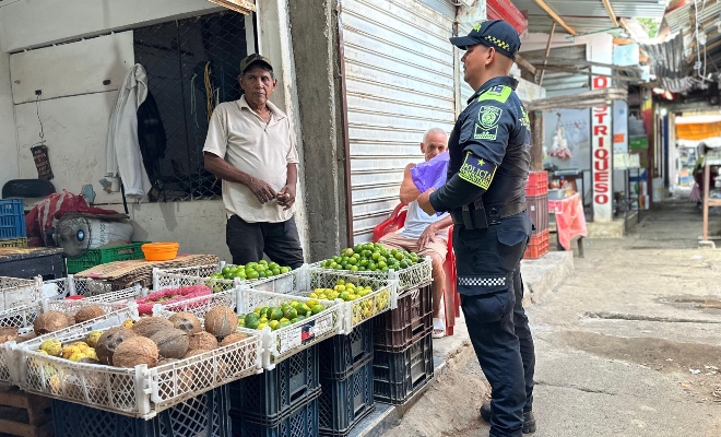 Funcionario policial brindando recomendaciones a un comerciante 