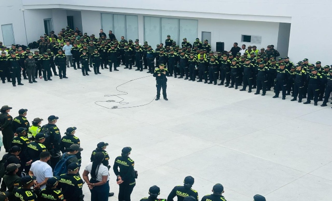un uniformado durante una formación, acompañado por varios integrantes de la Policía Nacional.