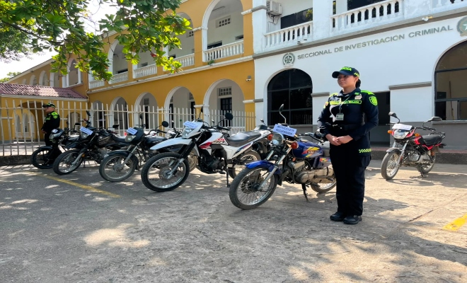 dos uniformados de la policía nacional en recuperación de  11 motocicletas en la ciudad de Montería