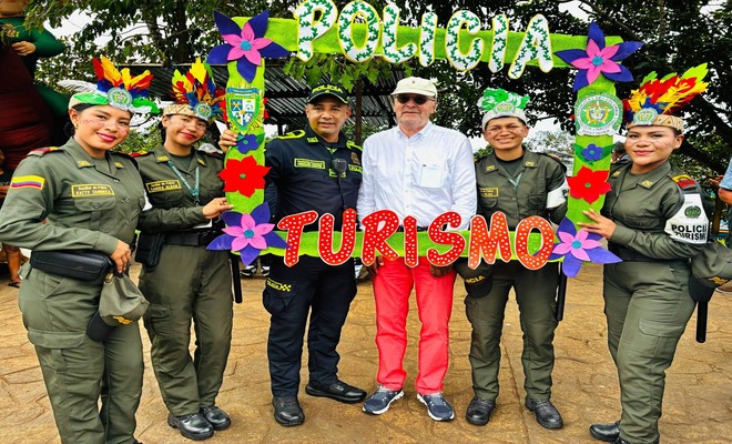 Cinco policías sujetando un cuadro de fotografías y un turista en el medio