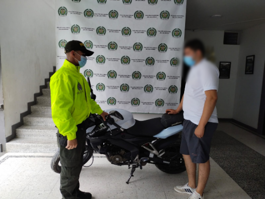 Policía entregando motocicleta recuperada